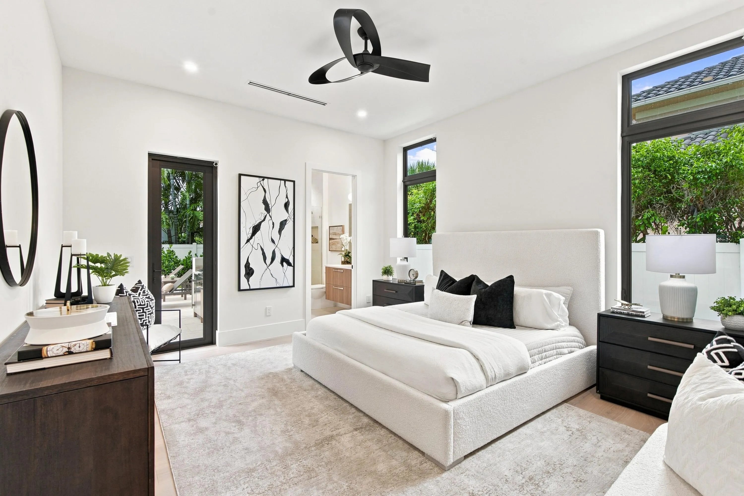 Recessed lighting, contemporary ceiling fan, large format windows, and a glass-paneled door