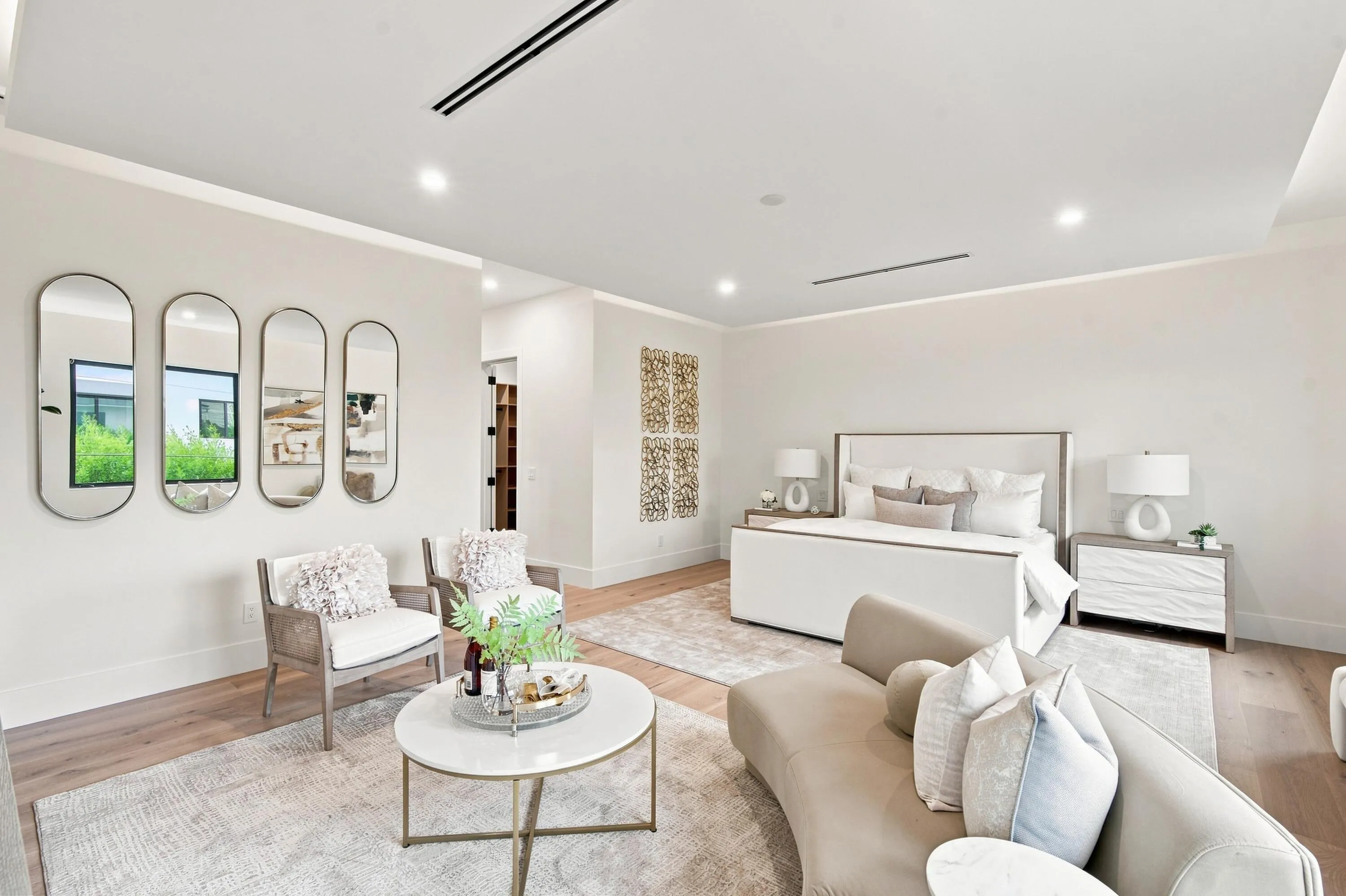 Recessed ceiling lighting, wood-finish flooring, tray ceiling, built-in shelving, and white walls