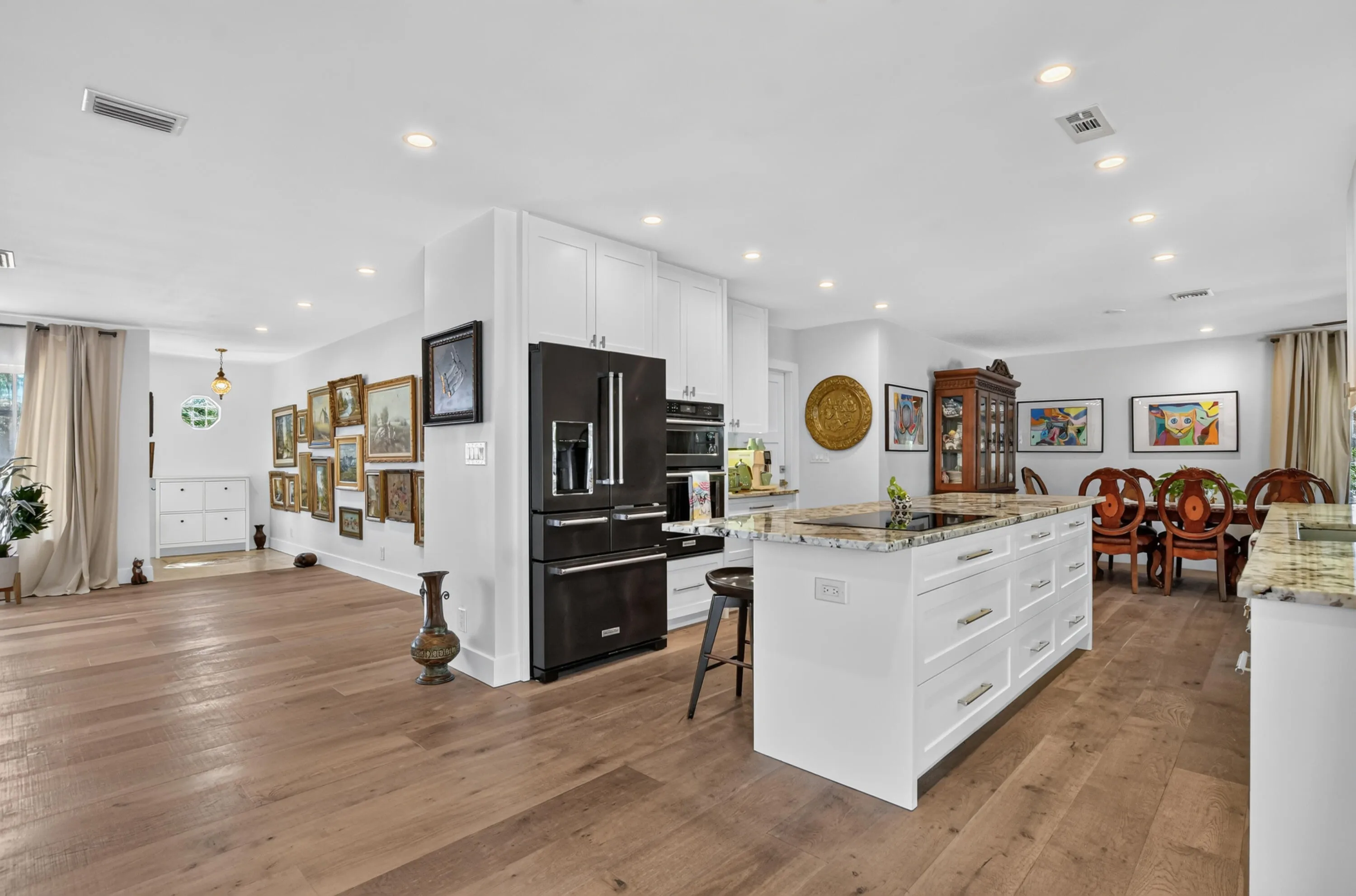 Kitchen featuring Kitchenaide French door black stainless steel fridge, wall oven and microwave and induction cooktop.