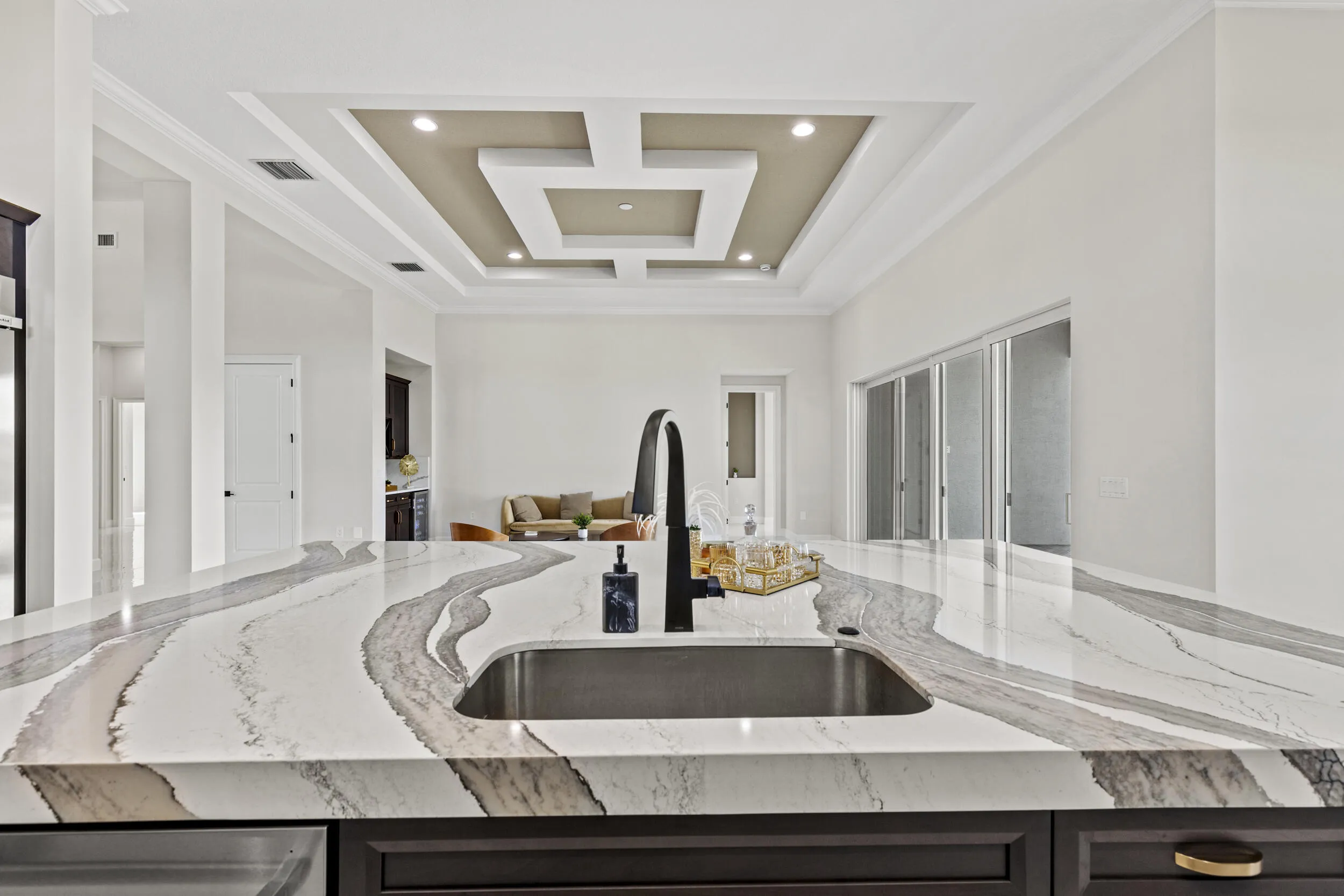 Expansive kitchen island featuring a deep undermount sink and a matte black gooseneck faucet