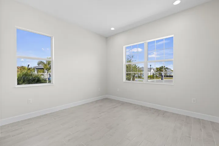 Bedroom 3 with recessed lighting, light-toned walls, wood-finish flooring, and multiple windows