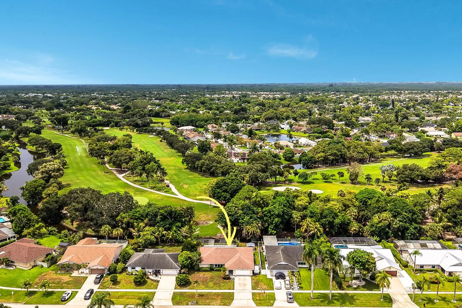 Aerial perspective with a golf course and water features