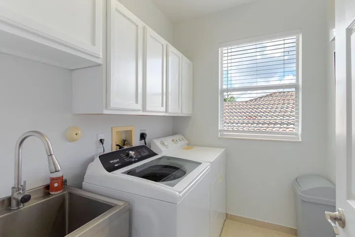 Convenient utility sink and new washer in laundry room!