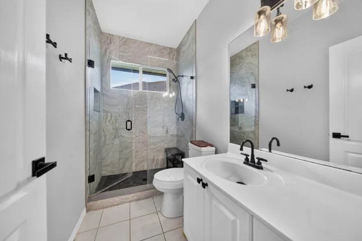 Frameless glass shower enclosure with tile surround