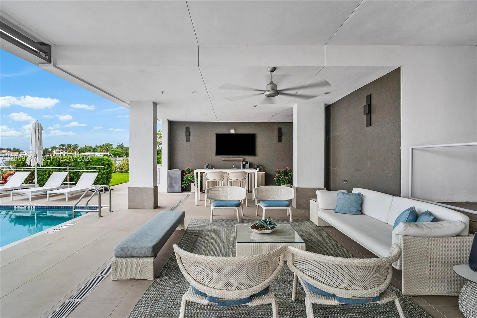 A covered poolside lounge provides a comfortable, shaded setting for relaxing and entertaining along the Intracoastal.
