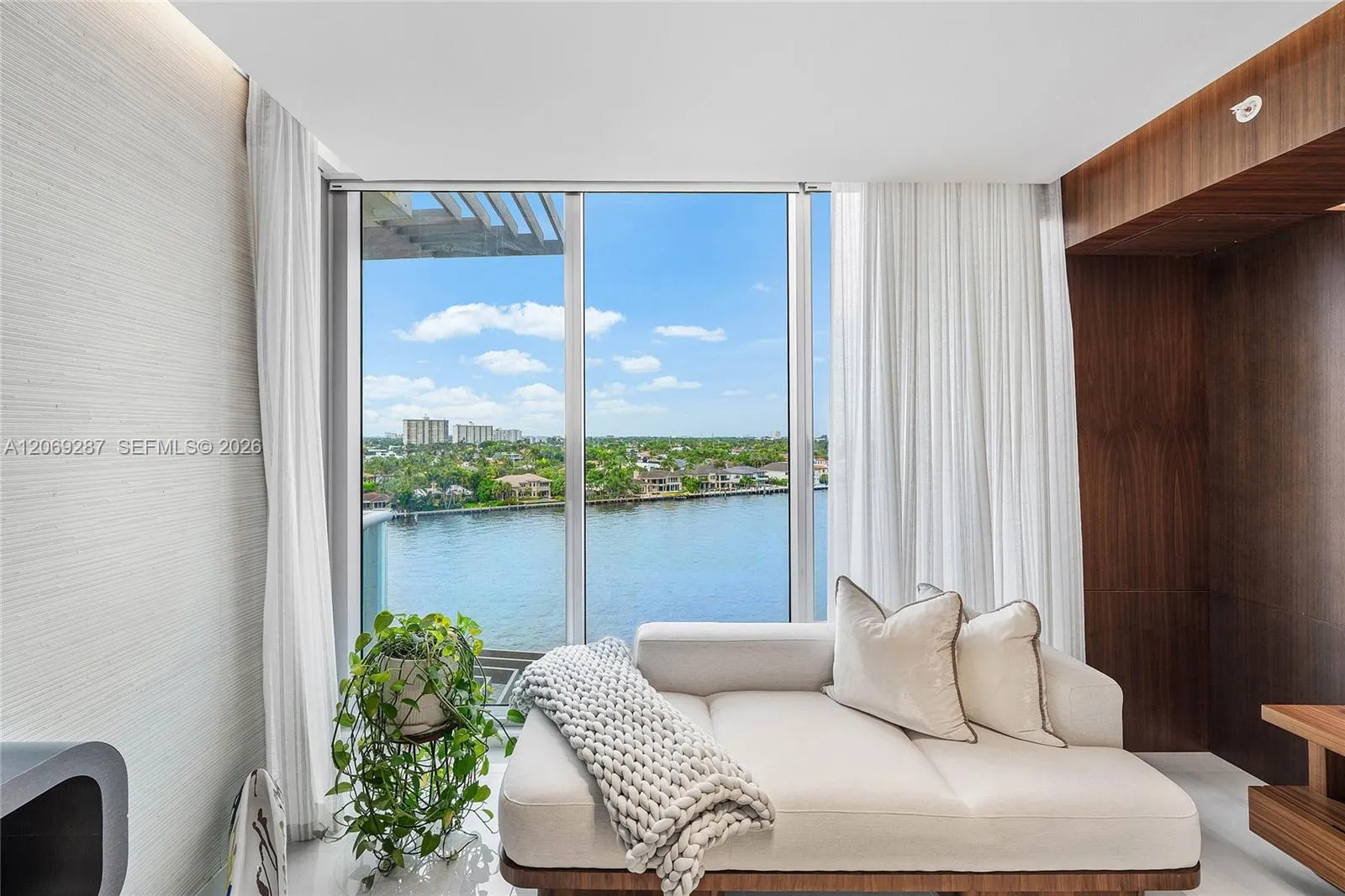 A private sitting area within the primary suite, perfectly positioned to enjoy the serene waterfront views.
