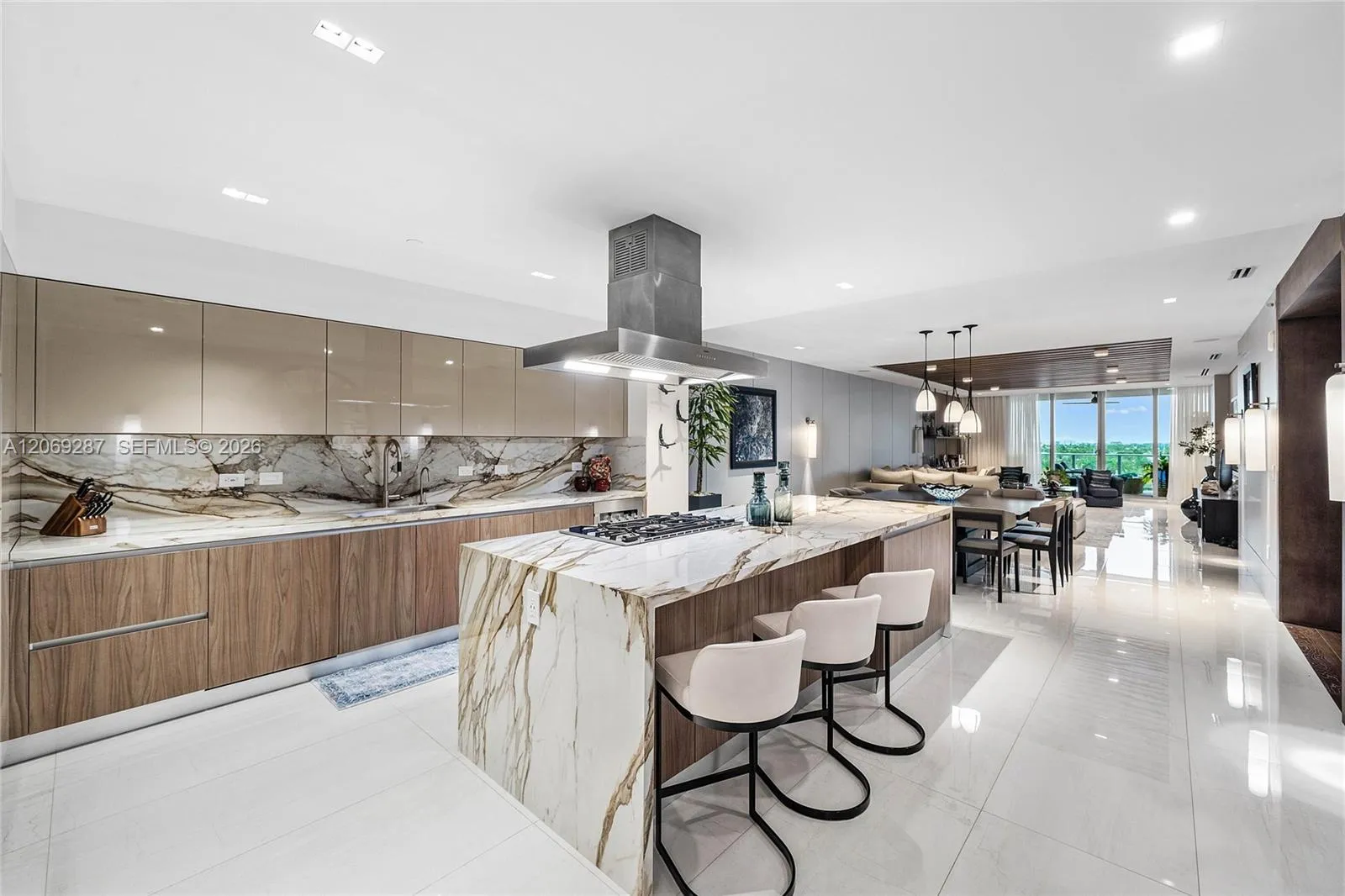 A sophisticated Italian-designed kitchen featuring custom cabinetry, premium Gaggenau appliances, gas cooking and an elegant island ideal for entertaining.