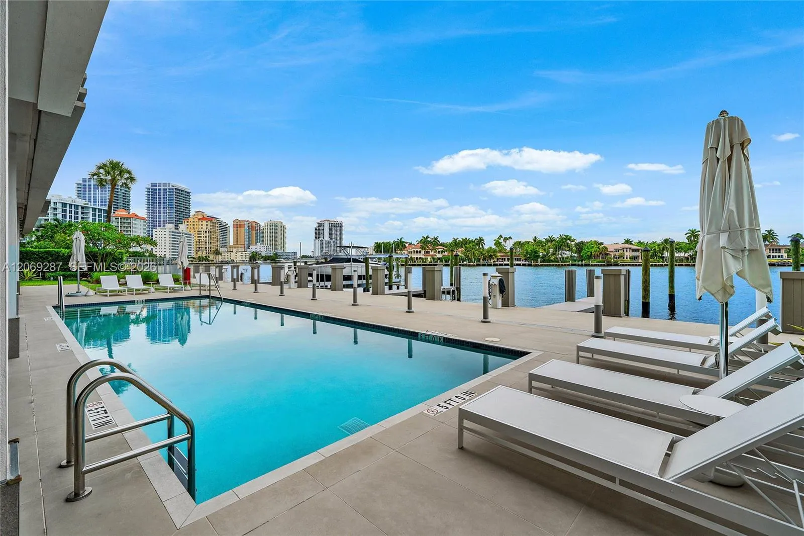 A covered poolside lounge provides a comfortable, shaded setting for relaxing and entertaining along the Intracoastal.