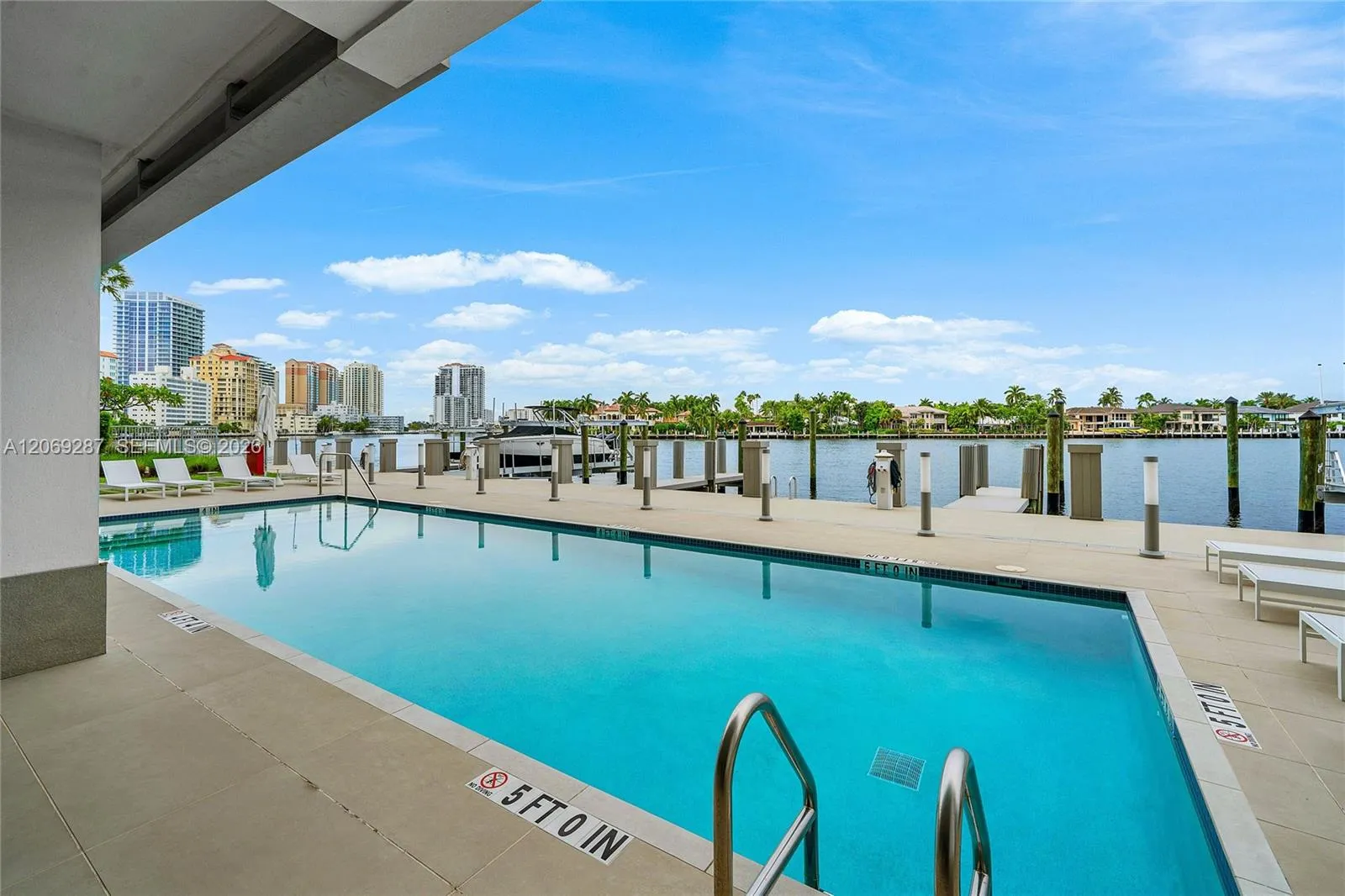A covered poolside lounge provides a comfortable, shaded setting for relaxing and entertaining along the Intracoastal.