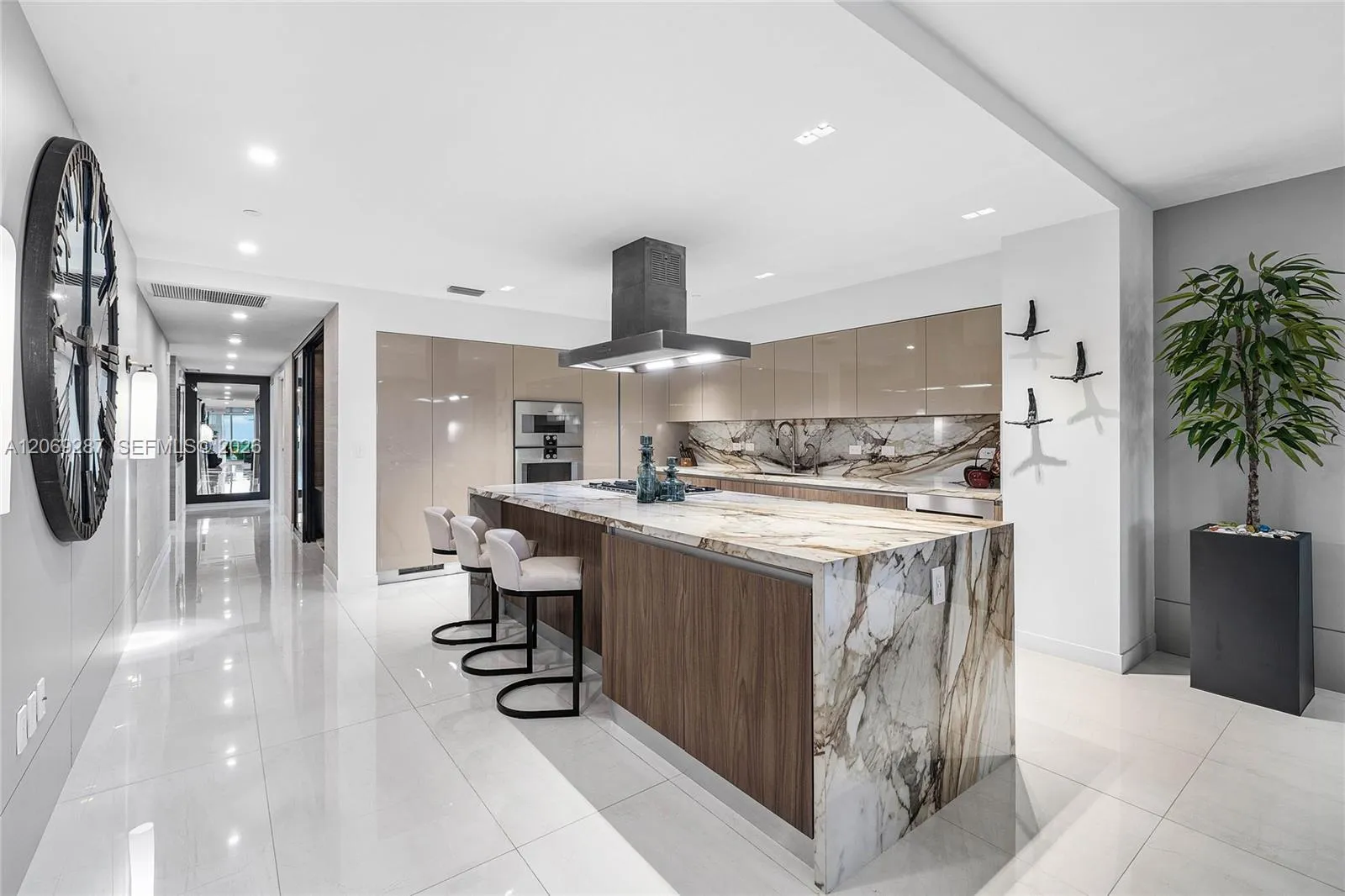 A sophisticated Italian-designed kitchen featuring custom cabinetry, premium Gaggenau appliances, gas cooking and an elegant island ideal for entertaining.