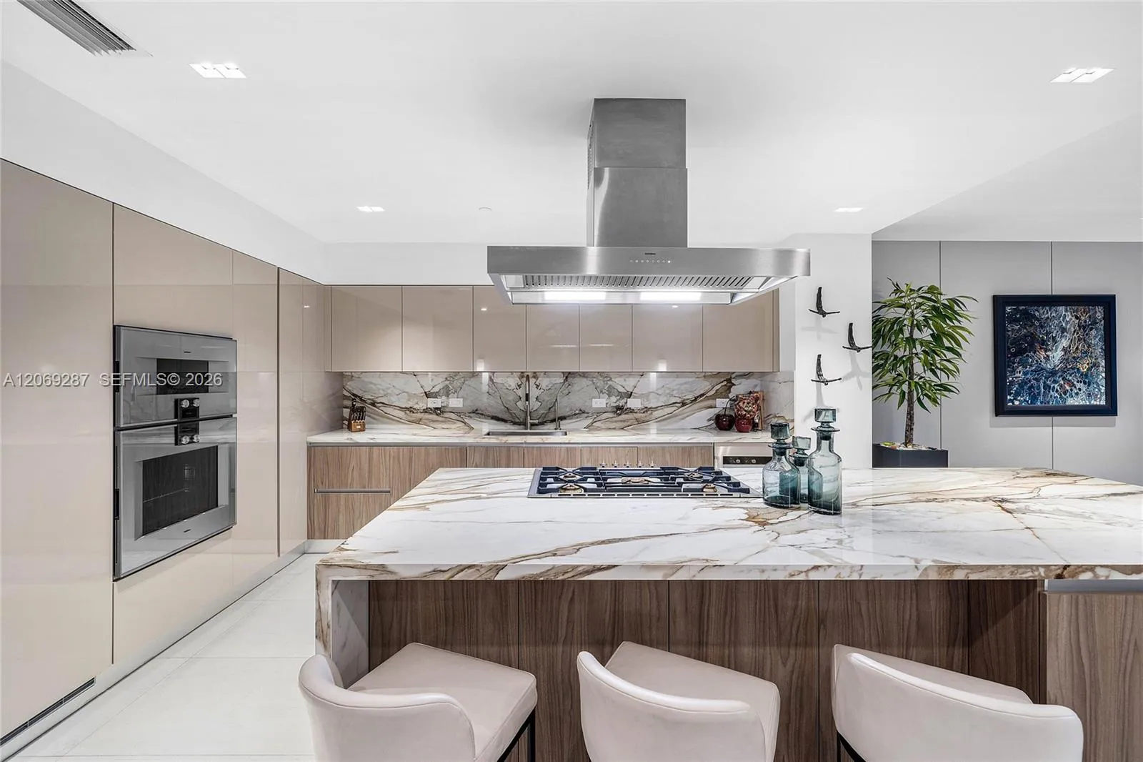 A sophisticated Italian-designed kitchen featuring custom cabinetry, premium Gaggenau appliances, gas cooking and an elegant island ideal for entertaining.