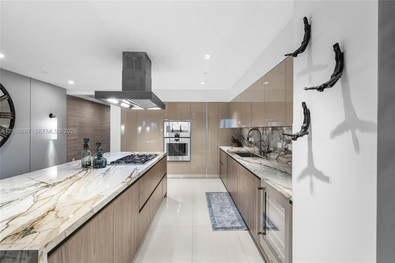 A sophisticated Italian-designed kitchen featuring custom cabinetry, premium Gaggenau appliances, gas cooking and an elegant island ideal for entertaining.