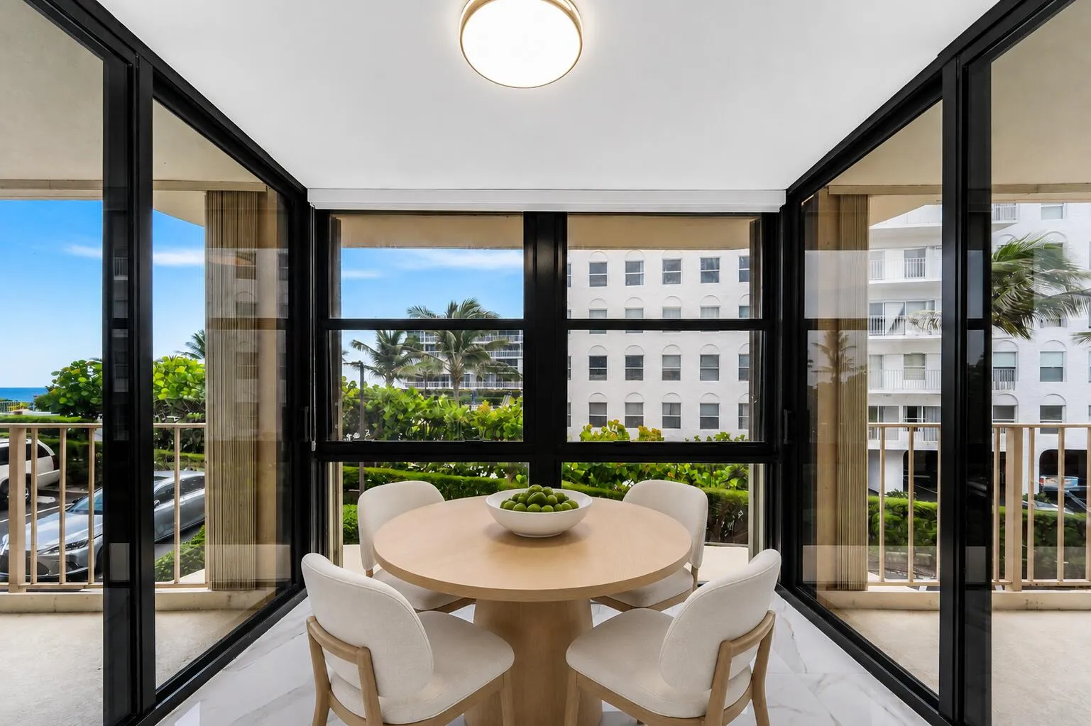 Expansive window-lined sunroom space with expansive views. Virtually staged.