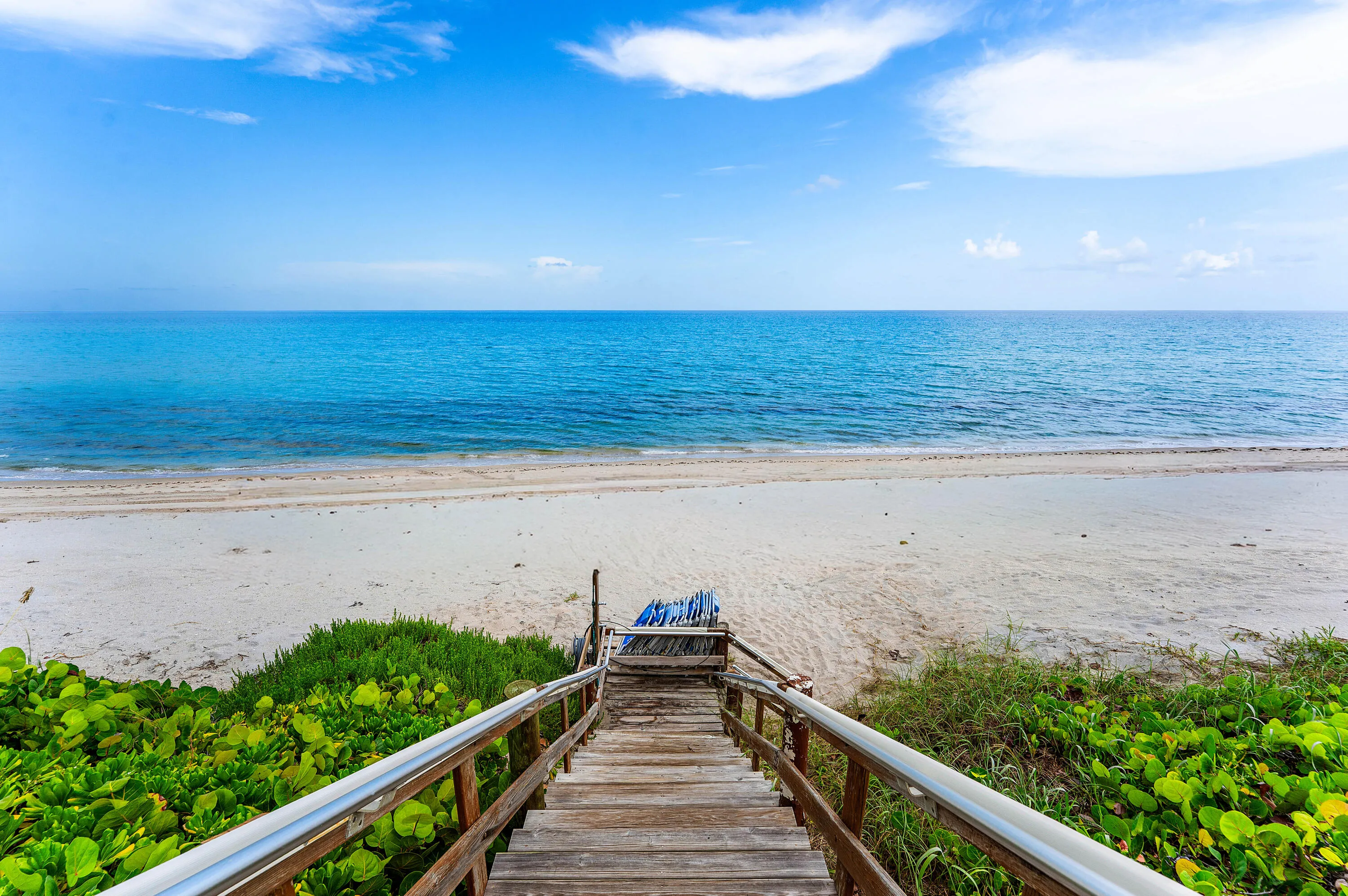 Direct beach access via locked gate and beach chairs.