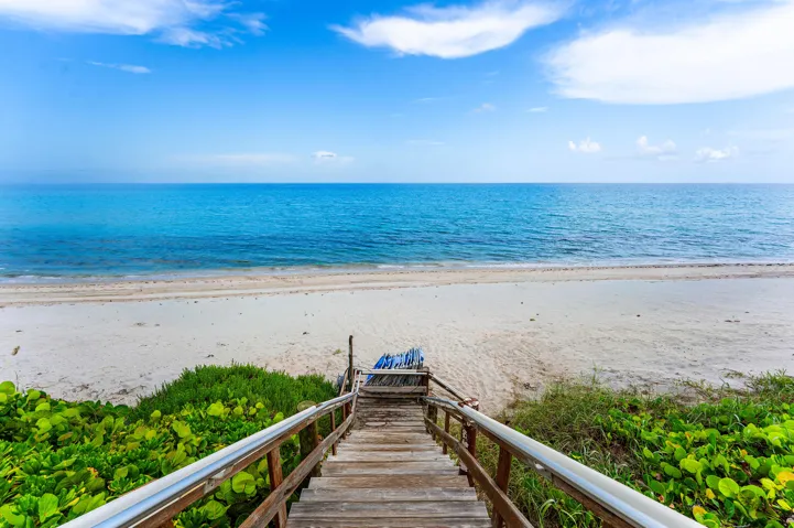Direct beach access via locked gate and beach chairs.