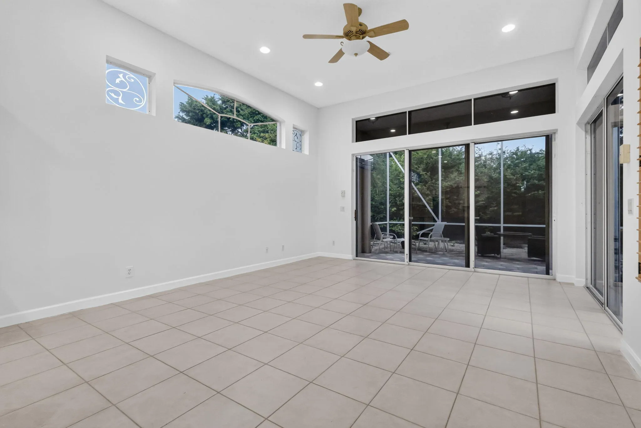 Recessed ceiling lighting, a ceiling fan, and large format floor tiling