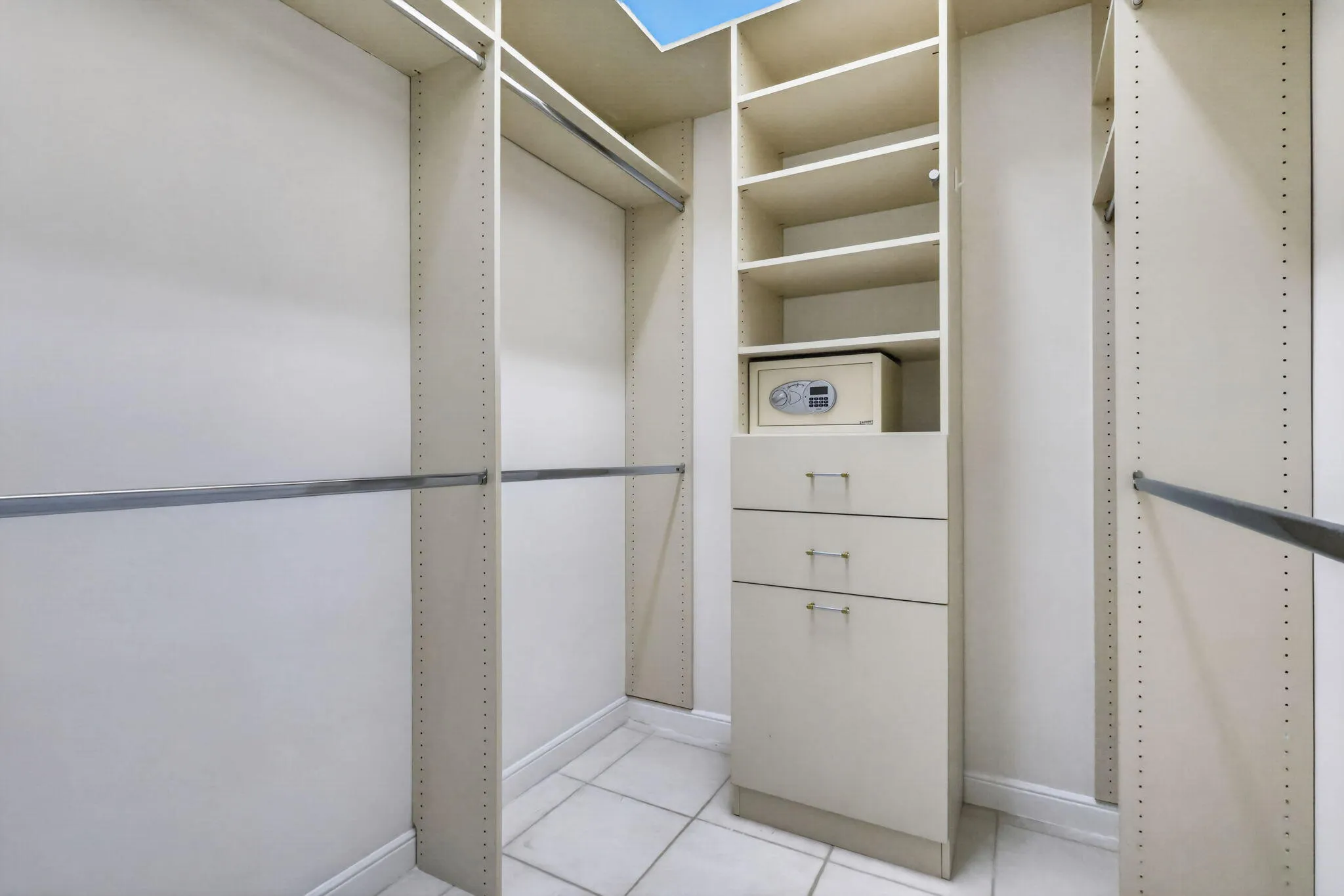 Custom closet system featuring multiple shelves, hanging rods, and drawers