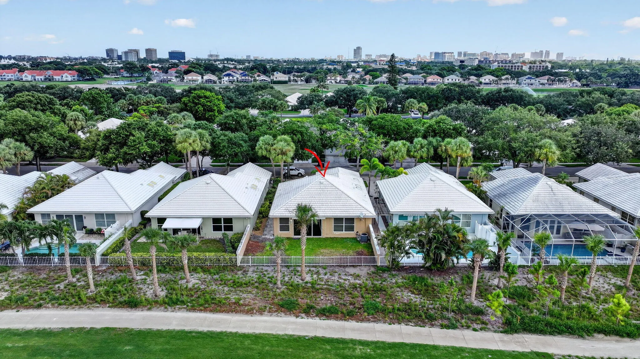 Single-story residence with a white hip roof and a light-colored exterior