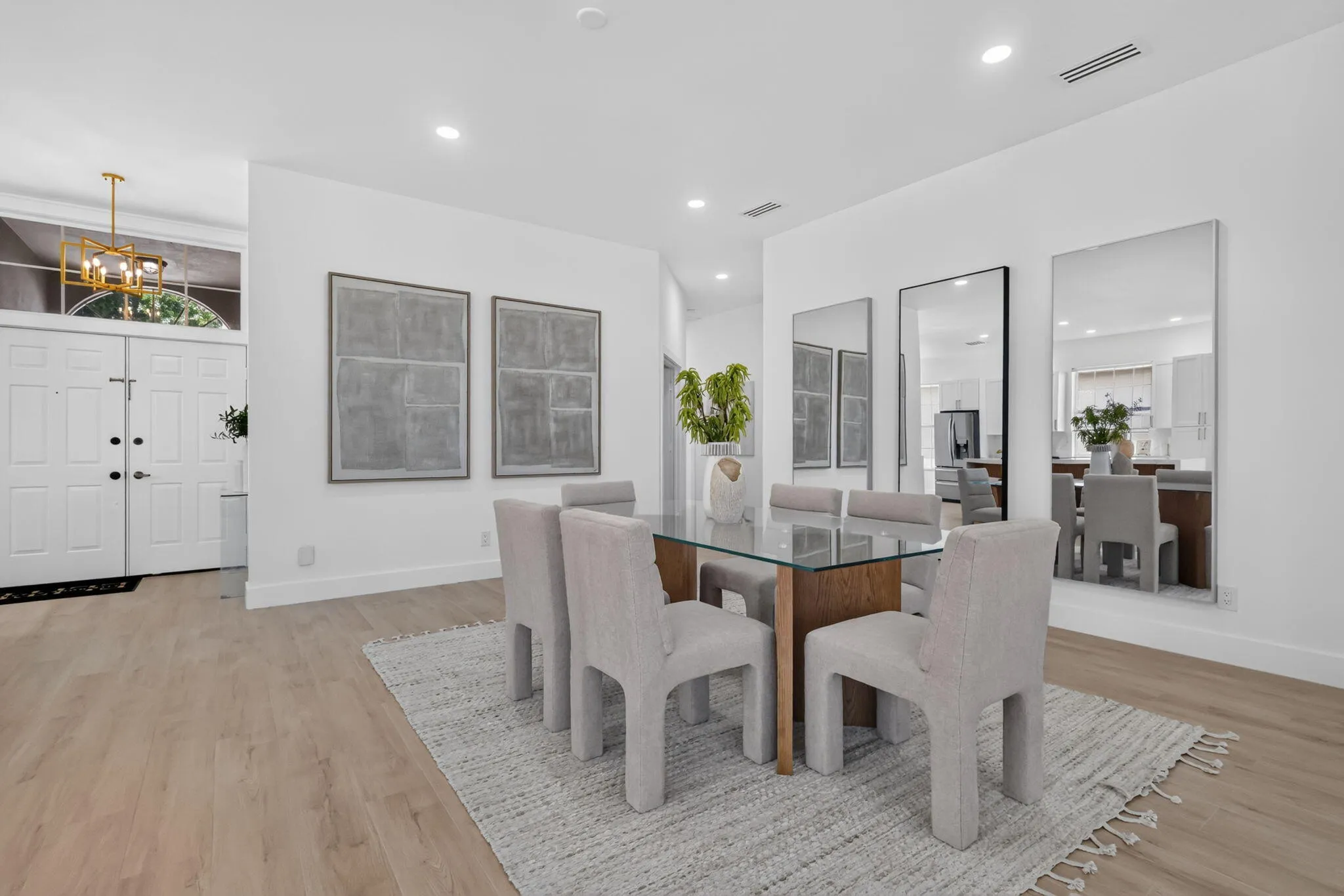 Recessed lighting, wood-finish flooring, and white walls