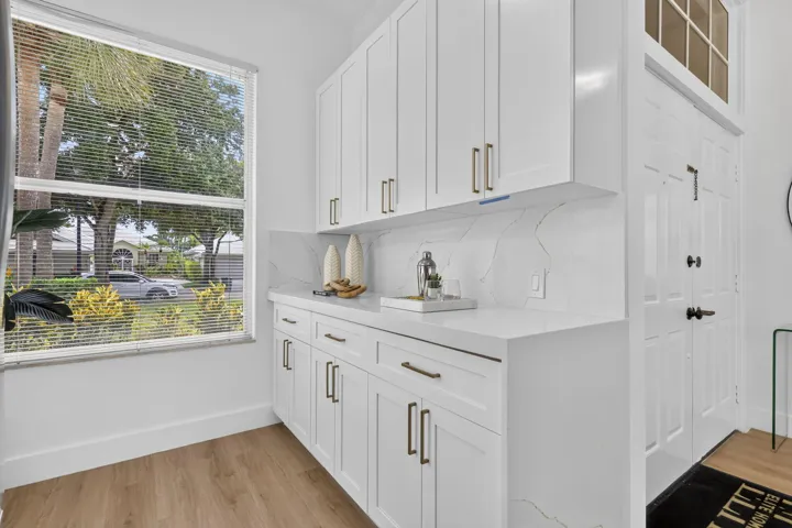 White shaker-style cabinetry with gold-tone hardware