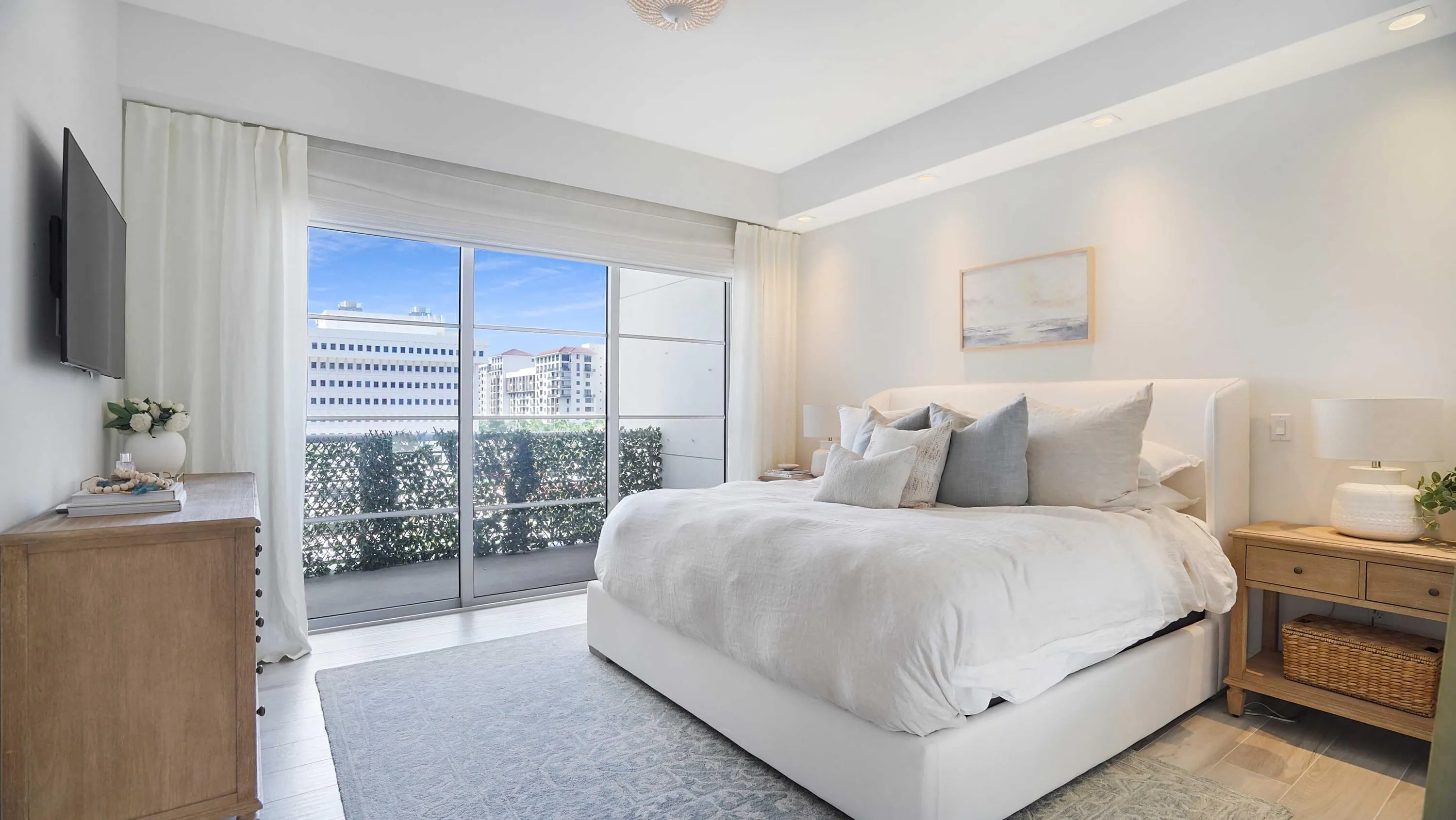 Natural light, tailored finishes and a private balcony shape the primary suite.