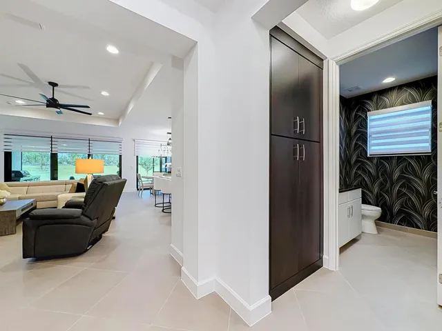 Foyer to Living Room with half bath off living room and kitchen