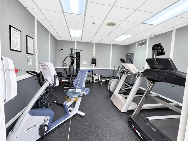 Featuring rubberized flooring, drop ceiling panels, and recessed lighting