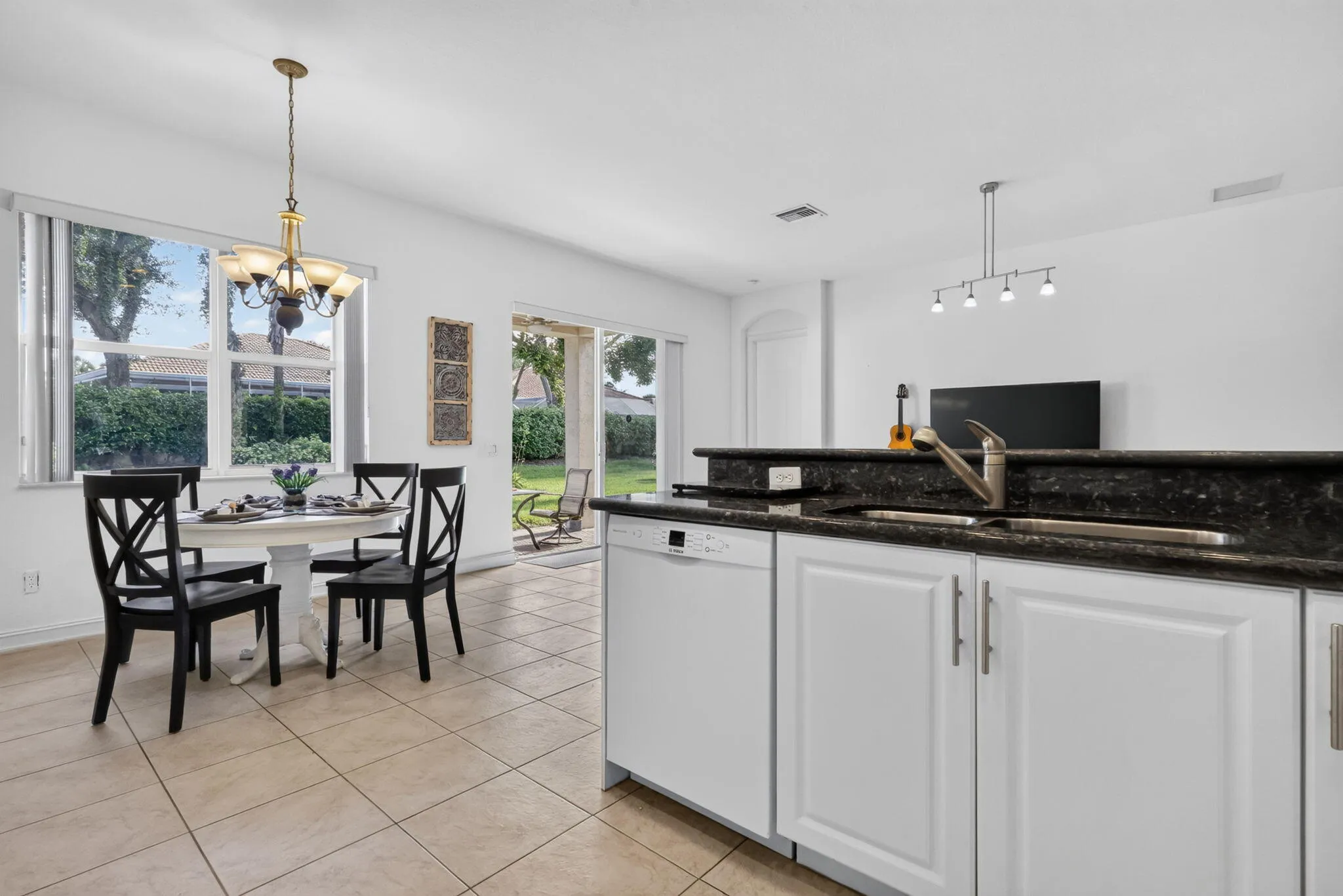 While preparing a meal or enjoying your morning coffee, the large dining room window brings the beautiful backyard into view.