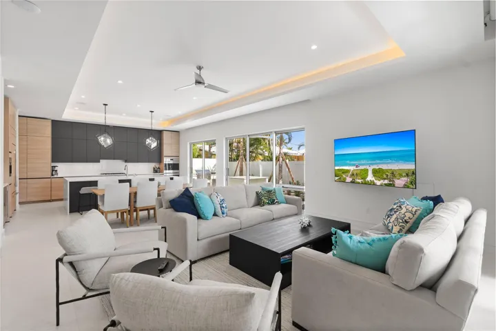 Open concept living area and kitchen - A remarkable luxury townhome rental that redefines upscale living in the heart of Lauderdale By The Sea. This beautifully designed 3,027 sq. ft residence features 4 spacious beds & 4 baths, making it perfect for families or those who love to entertain.The home also offers an outdoor kitchen and BBQ area, along with a private plunge pool that invites relaxation and fun. For boating enthusiasts, a boat slip is also available for rent. Easy access to a plethora of amenities, beach, dining, & entertainment.