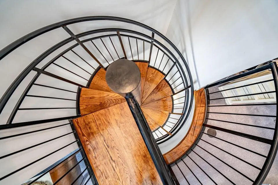 spiral stairs going up to bedroom'