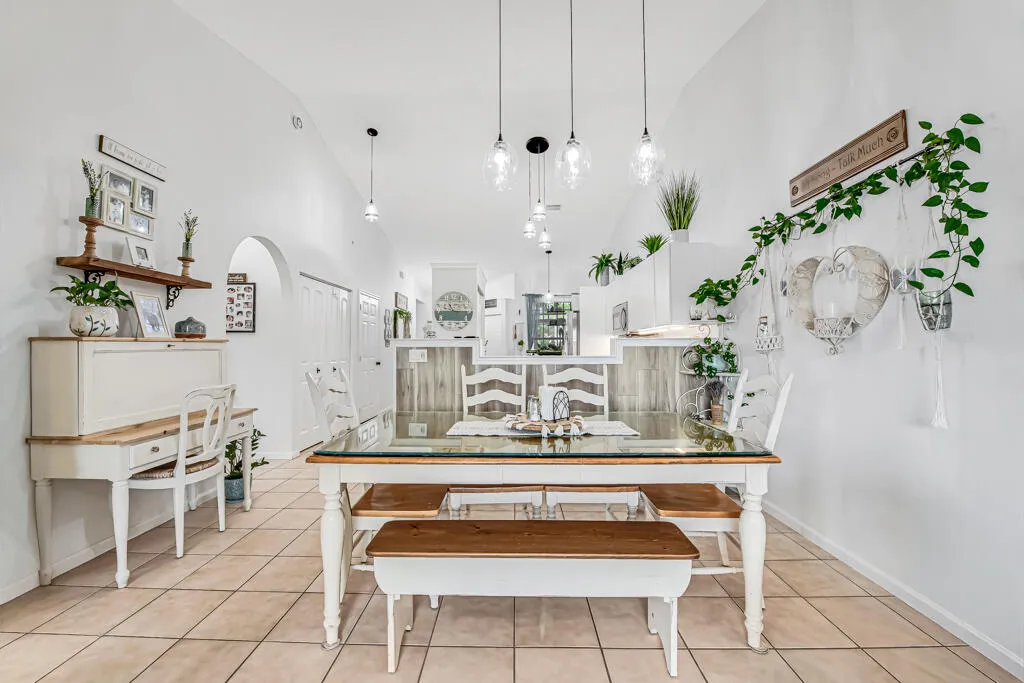 Tile flooring, vaulted ceiling, arched doorway, recessed lighting, pendant lighting