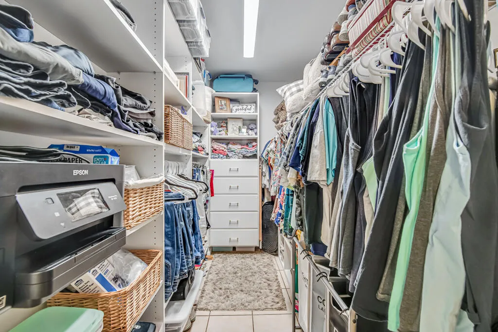 Custom closet system featuring extensive shelving, hanging rods, and built-in drawers