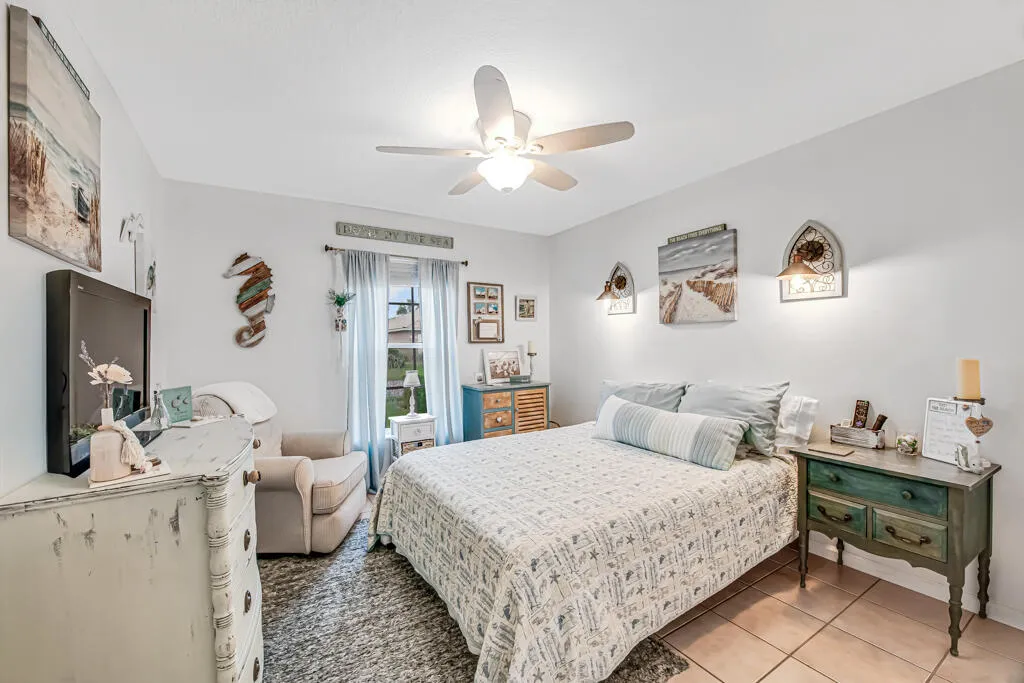 Recessed window with white trim, ceiling fan with integrated lighting, and tile flooring