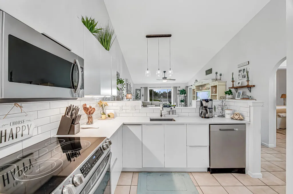 White shaker cabinetry with an integrated sink and gooseneck faucet