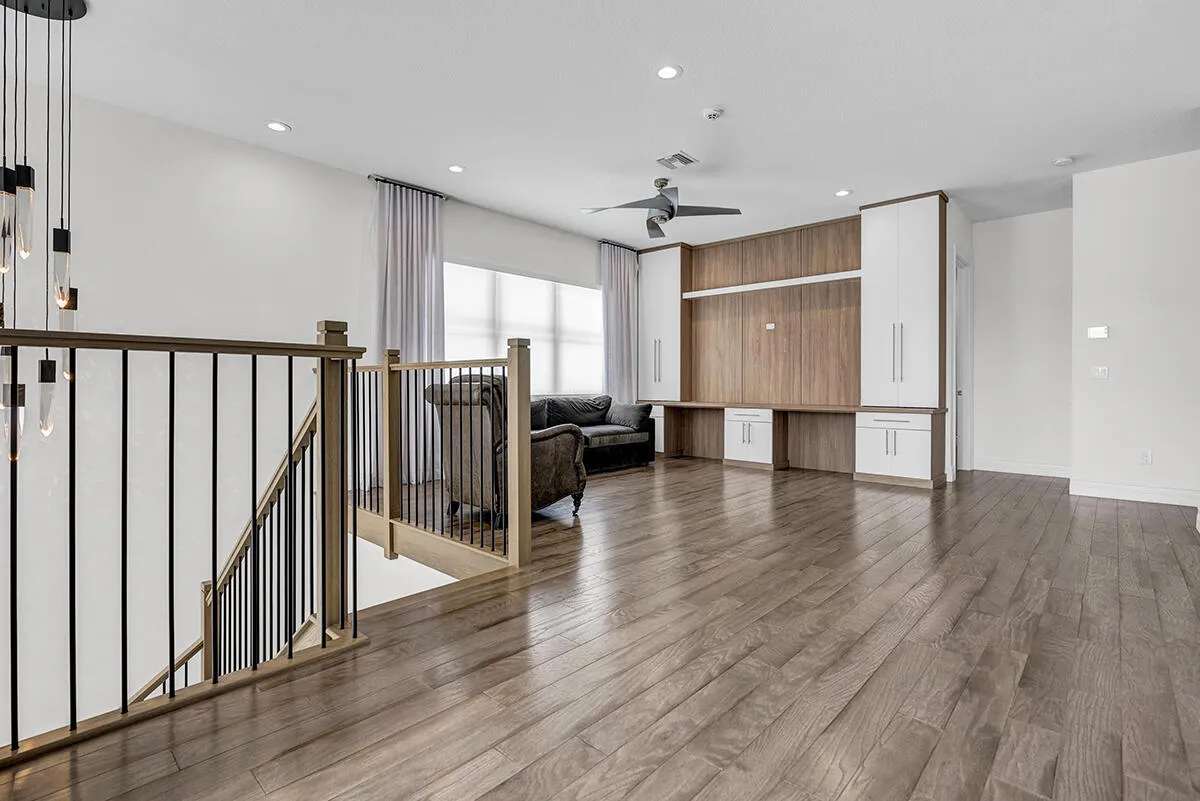 Open concept living area featuring wood-finish flooring, a contemporary ceiling fan, and recessed lighting