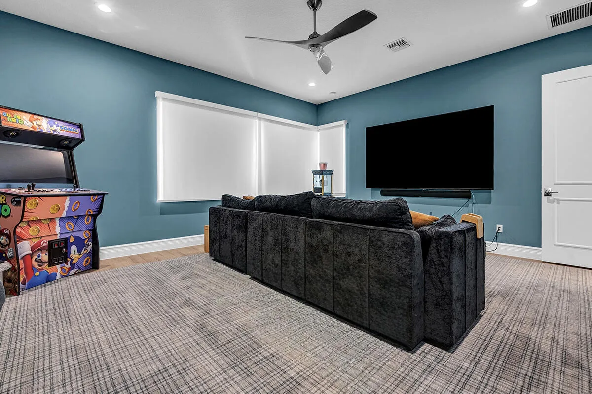 Room featuring blue accent walls, recessed lighting, and a modern ceiling fan