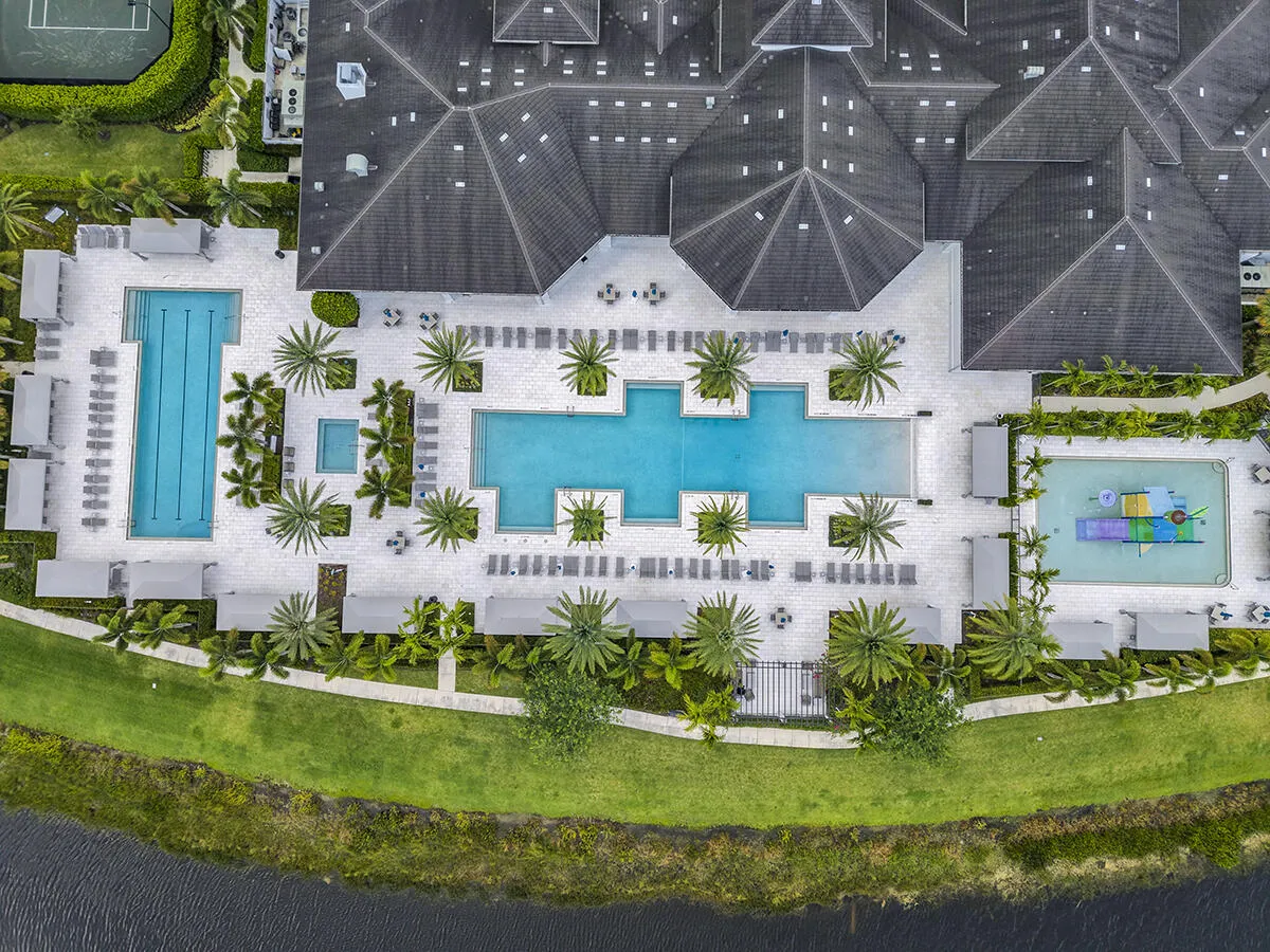 Expansive aquatic facility featuring multiple pools, an aquatic play area, and extensive lounge seating