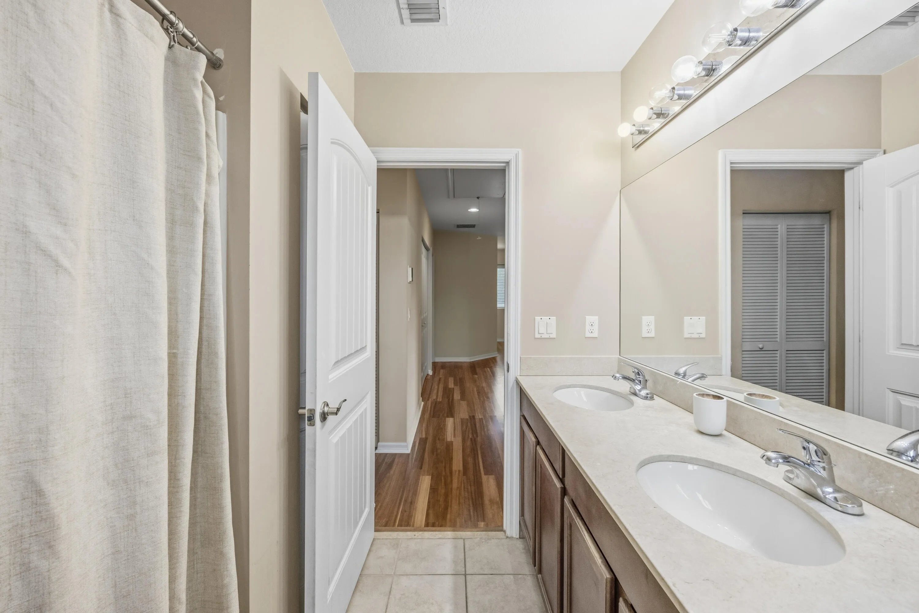 Dual vanity with undermount sinks, chrome fixtures, and a light-toned countertop