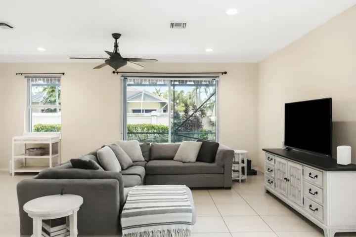 Recessed lighting, ceiling fan, tile flooring, sliding glass door, and large window