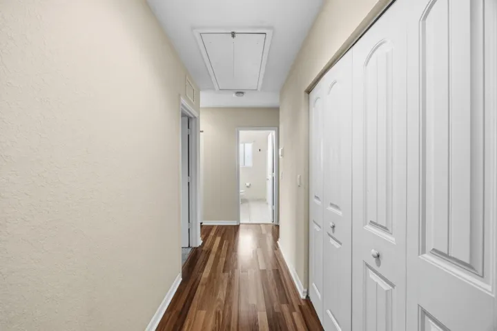 Wood-finish flooring throughout, neutral tone walls, and white bi-fold closet doors