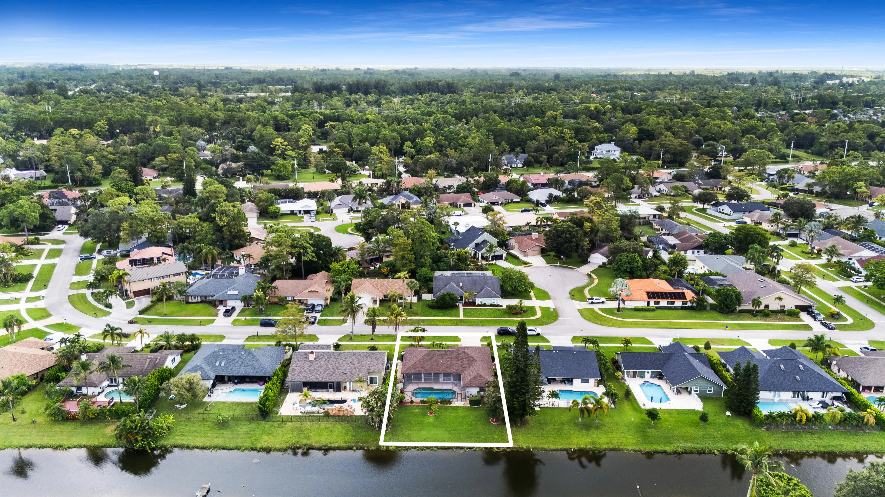 Aerial perspective of a residential neighborhood featuring established homes with dark-toned roofs