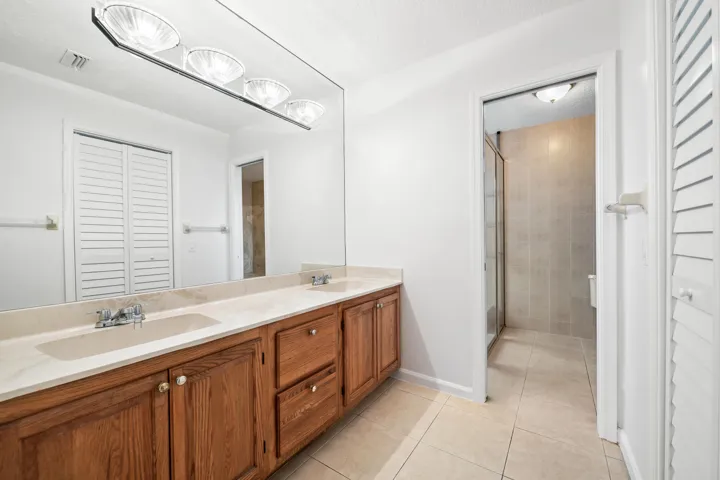 Dual vanity with wood-finish cabinetry and integrated sinks