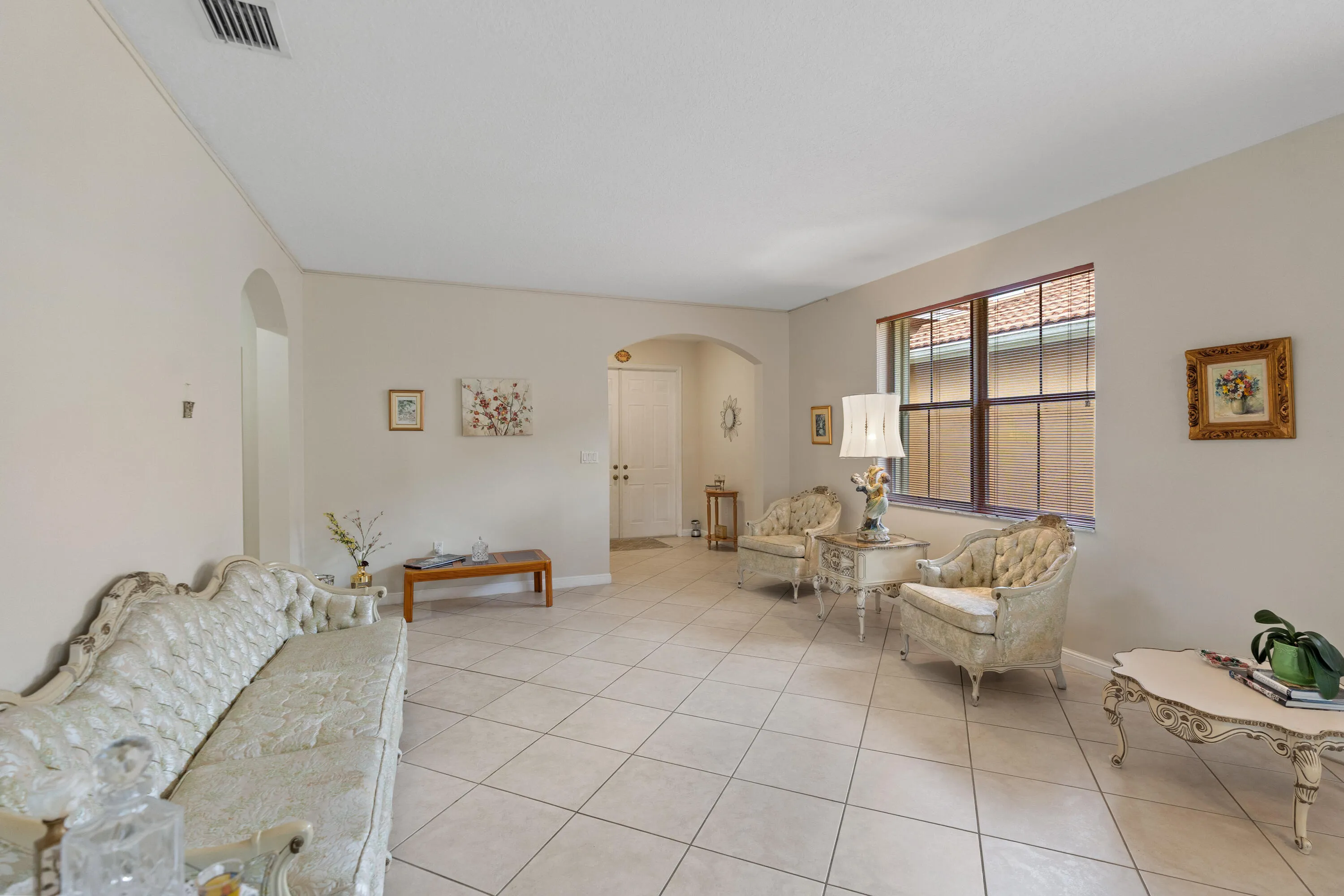 Formal living & dining with an open, airy feel. The home has high ceilings, tile floors and spacious rooms through the home.