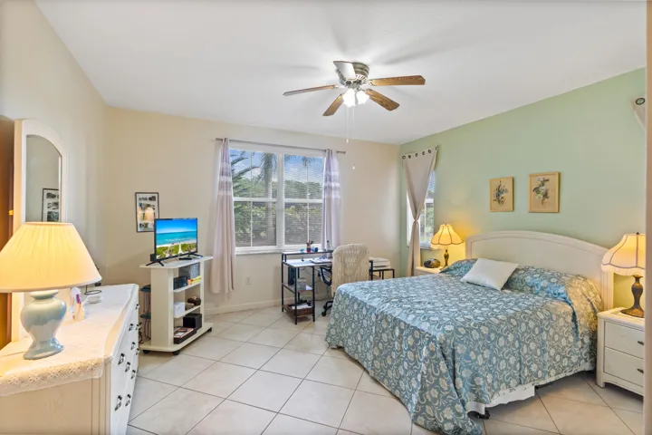 Spacious primary bedroom featuring tile flooring, a huge walk-in closet and ensuite bathroom.