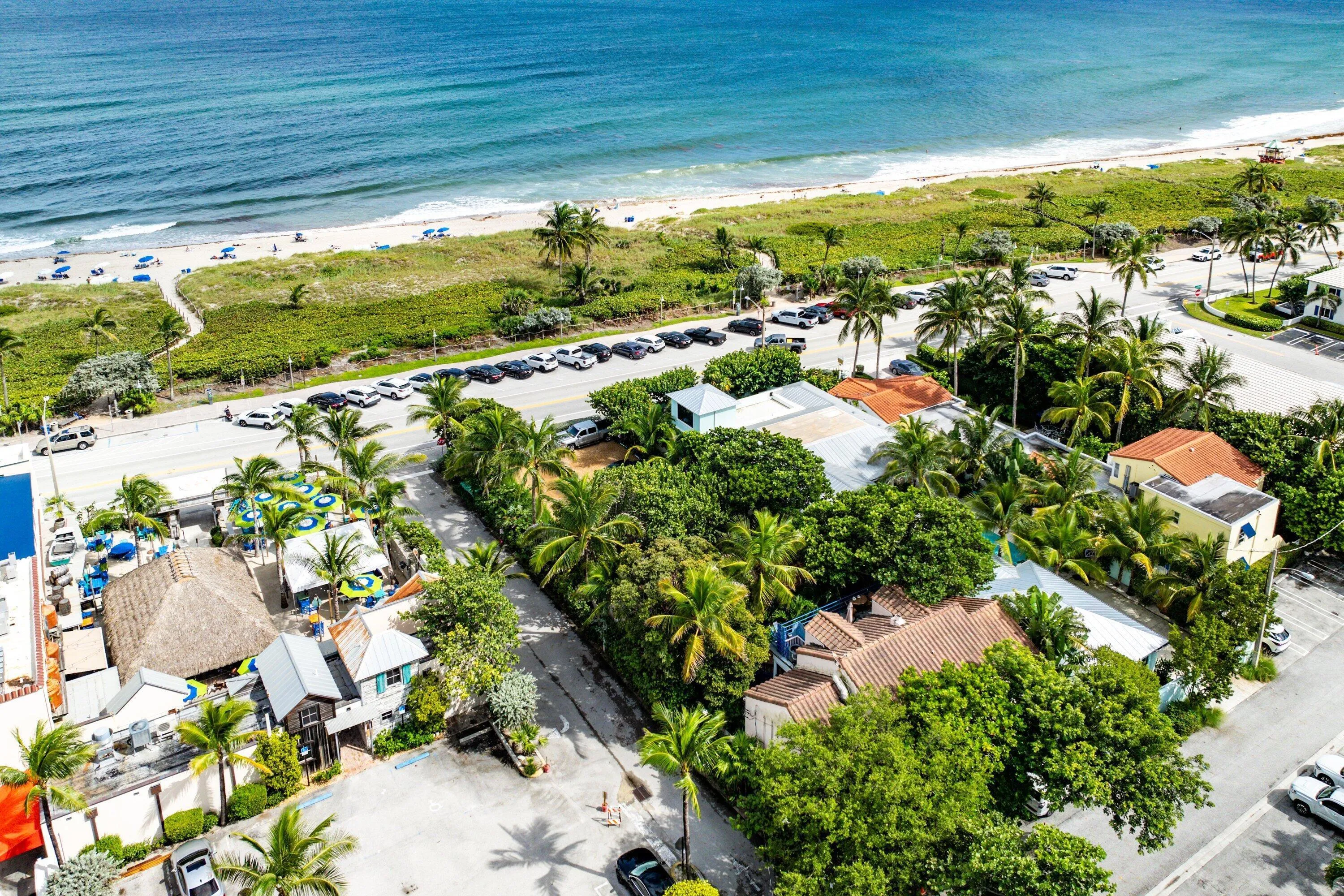 Coastal property with direct beach access and lush, mature landscaping
