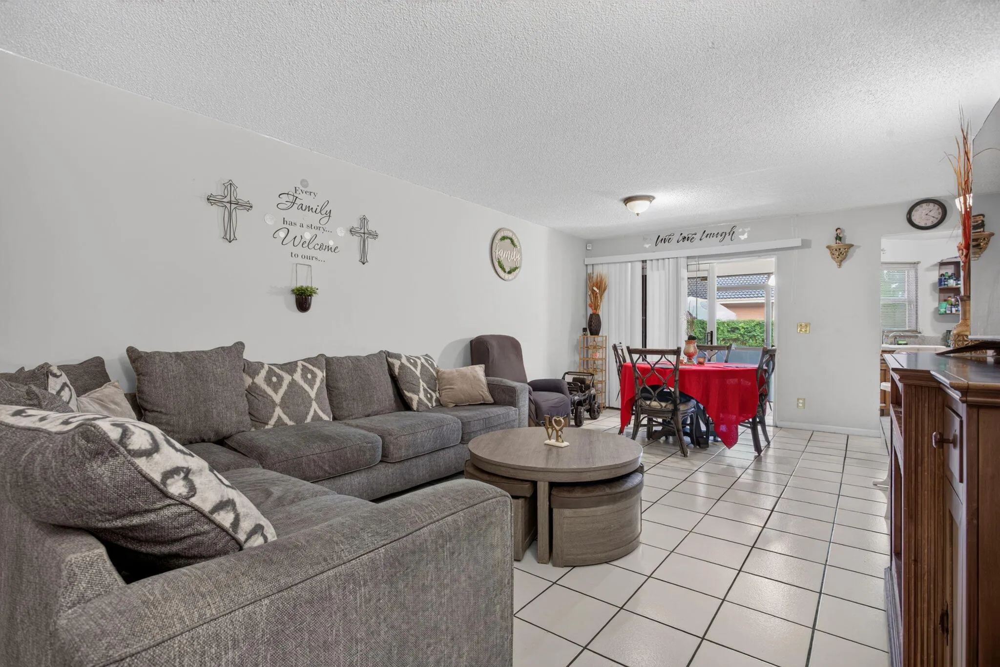 Living room with a large screened balcony patio.