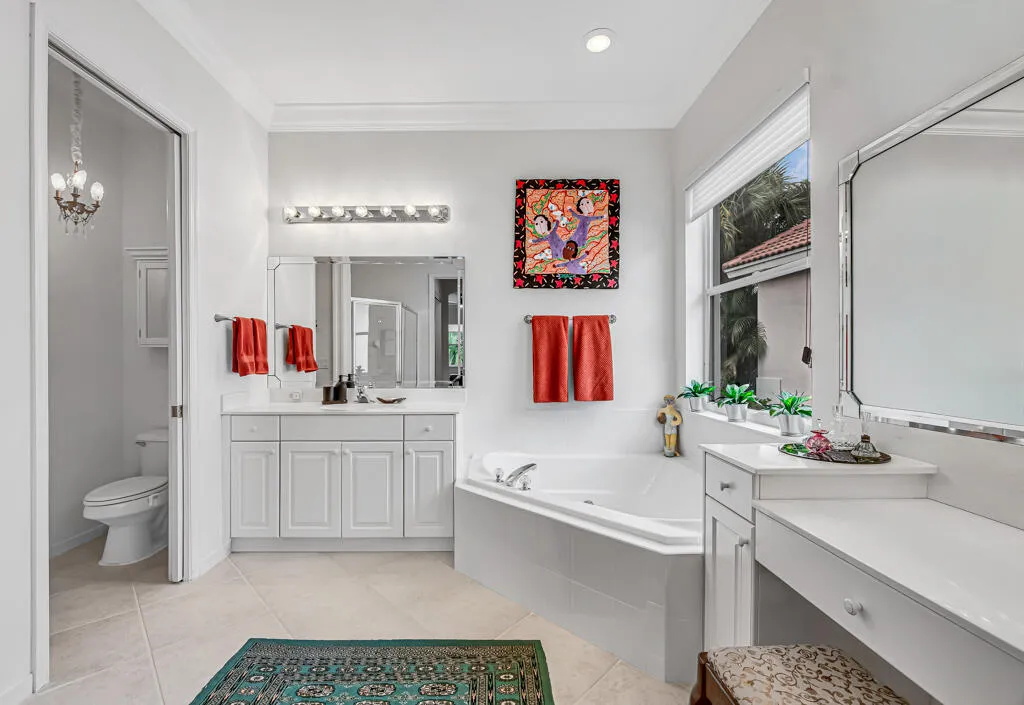 Primary bathroom with double vanities, separate walk-in shower and soaking tub
