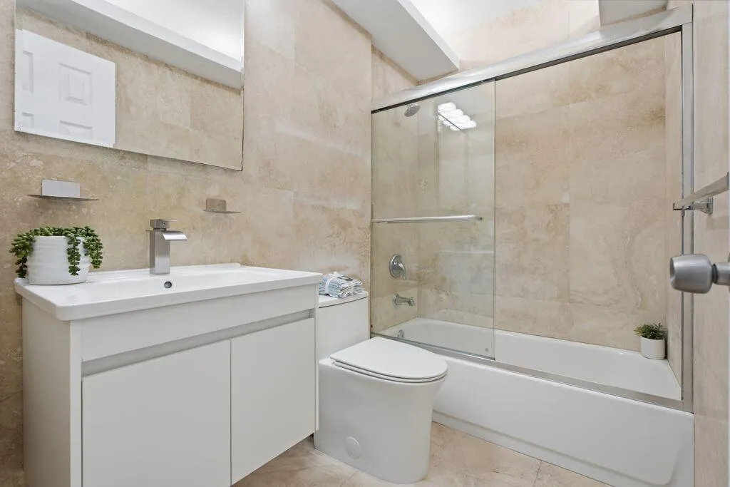 Marble Bathroom with overhead lighting, new vanity, toilet