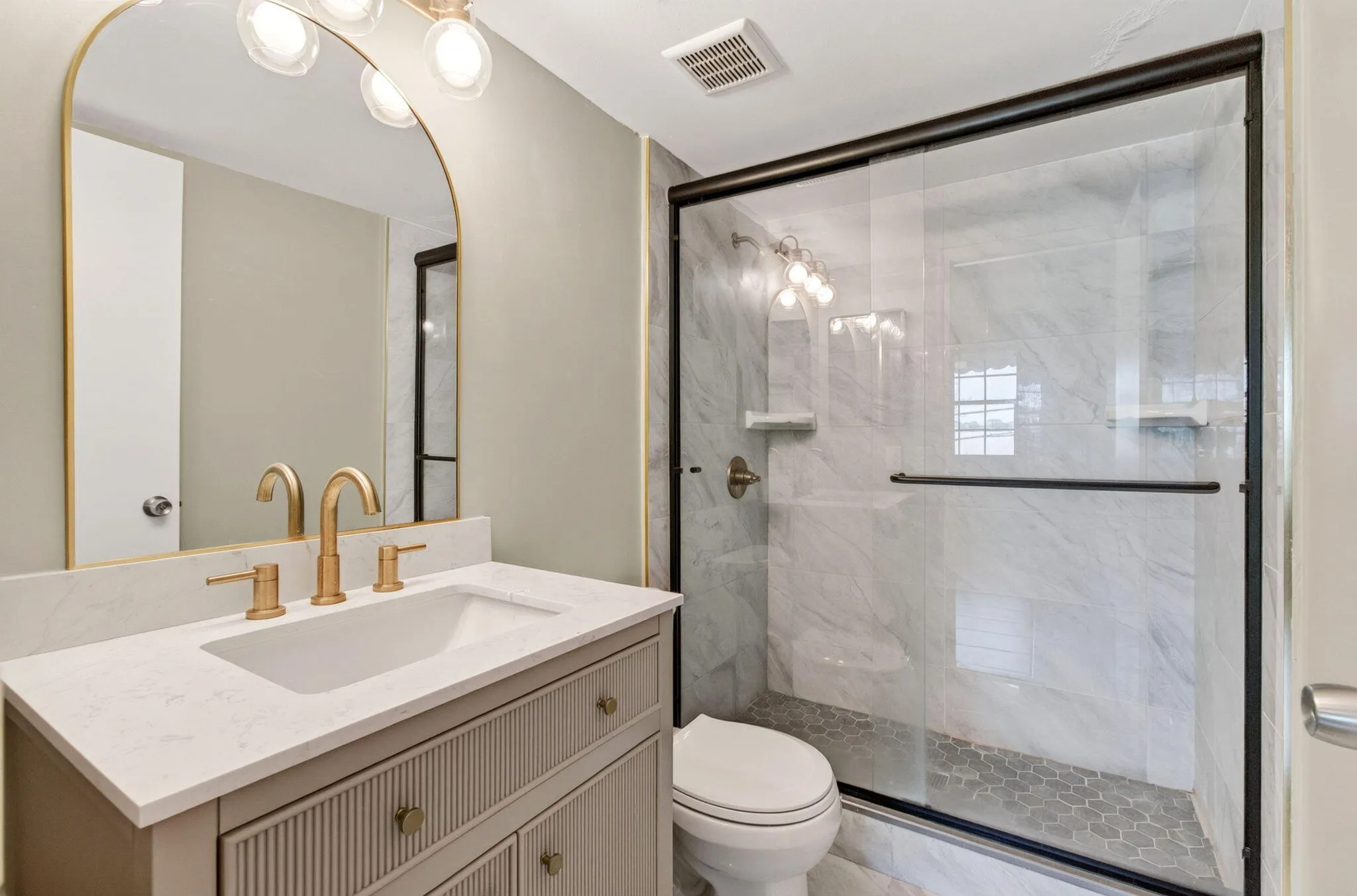 Modern vanity with an integrated sink and gold-tone hardware