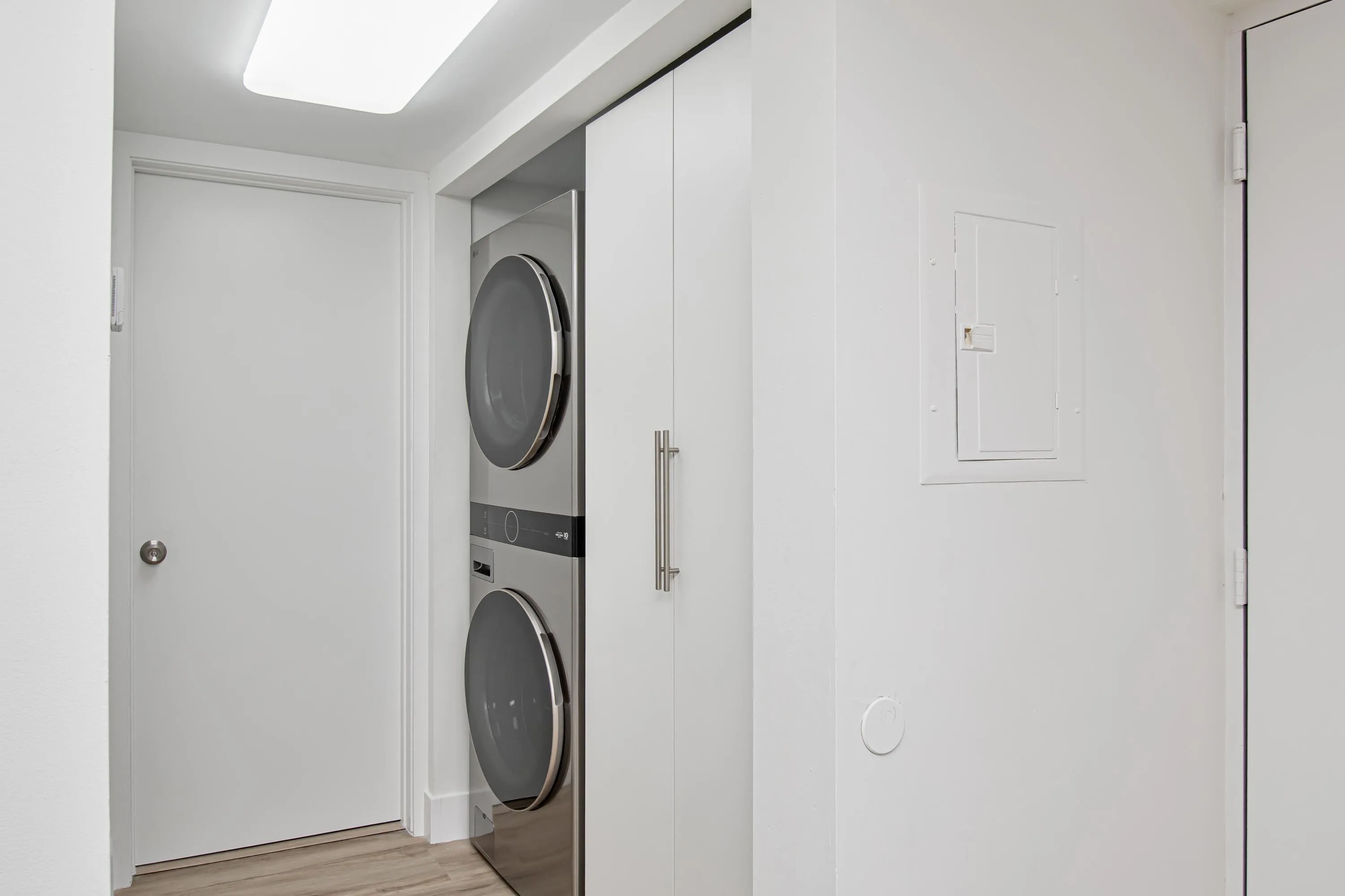 In-unit stackable washer and dryer, wood-finish flooring